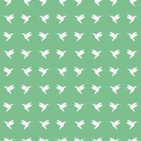 Seamless pattern of flying Hummingbirds from the side. White silhouette of a bird in profile on a green background. Tropical and exotic fauna. Animal shape. Vector illustration.