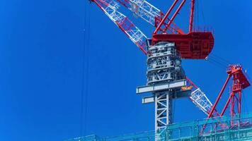 A timelapse of crane at the under construction daytime long shot tilt video