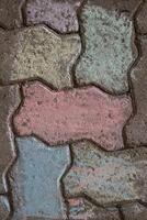 Chalk drawings on sidewalks. A beautiful colorful geometrical ornament chalk drawing from above. Pavement painted with multicolored chalks. Top view. photo