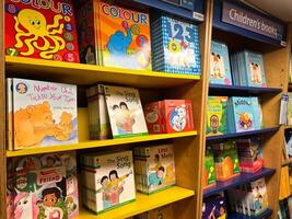 Herceg-Novi, Montenegro - 17 august 2023. Colorful children books with fairy tales and stories stand on the shelves photo