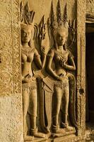 Apsara on the Stone Wall Carving of Angkor Wat at Siem Reap Province of Cambodia photo