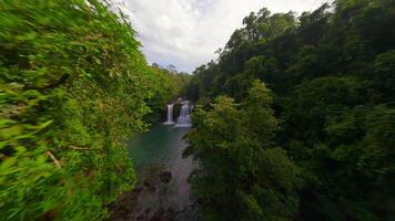 Aerial view of tropical waterfall among the lush jungle in Thailand video