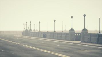 An empty illuminated asphalt road in a thick fog video