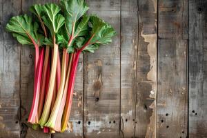 AI generated Freshly harvested rhubarb stalks arranged neatly on a rustic wooden table, creating a background with empty space for text about the rhubarb cultivation process photo