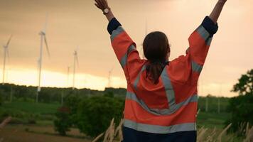 Smart engineer with protective helmet rising hands up  at electrical turbines field video