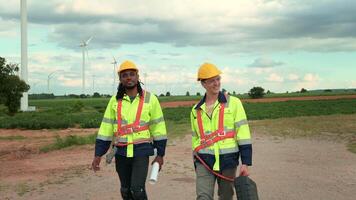 Engineer is walking in a field wearing a protective helmet on  head video