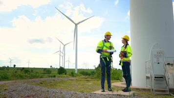 Smart engineer with protective helmet holding the blueprint working at electrical turbines field video