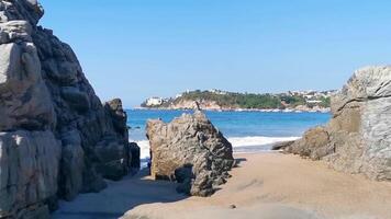 Beautiful rocks cliffs surfer waves at beach Puerto Escondido Mexico. video