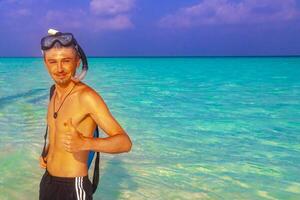 Man with snorkeling equipment fins and snorkeling mask Maldives. photo