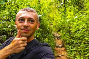 Man tourist Tropical jungle forest hiking trails Chiang Mai Thailand. photo