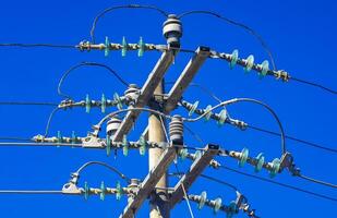 Power pole cable box with blue sky in Mexico. photo