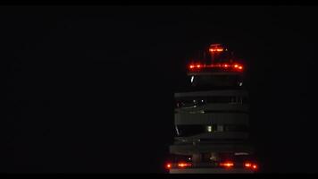 Airport tower at night overseeing takeoff video