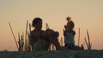 Siblings constructing bamboo enclosure at sunset video