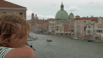 Child gazing at Venice historic architecture video