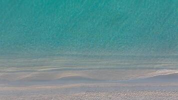 Aerial top-down view of sparkling sea textures at the beach video