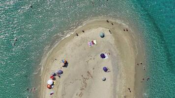Aerial footage of isolated sandy spit with swimmers video