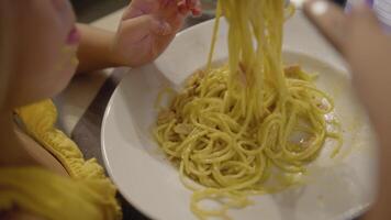 Little girl having spaghetti for dinner video