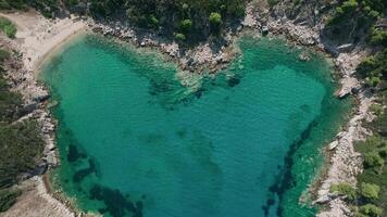 Hidden emerald heart-shaped cove aerial ascent video