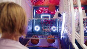 Teen at the arcade basketball game video