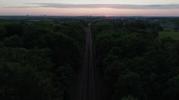 Aerial retreat from oncoming suburban train video