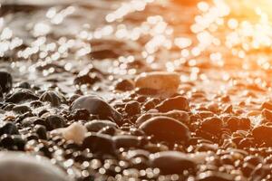 Blurred golden sea at sunset. The sun reflects and sparkles on the waves with bokeh, illuminating the golden sea. Holiday recreation concept. Abstract nautical summer ocean sunset nature background. photo