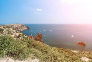 Sea lagoon. Panoramic view on calm azure sea and volcanic rocky photo