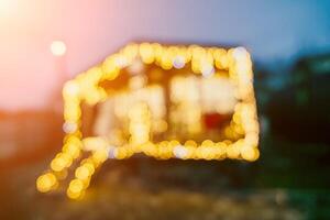 Abstract defocused bright Christmas lights on wooden house, creating decorative illumination in evening scene photo