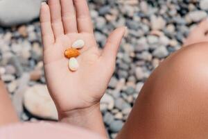 Woman eating milky almond nuts. A young caucasian woman chopping fresh green almond after morning fitness yoga near sea. Only hands are visibly. Healthy vegan food. Slow motion. Close up photo