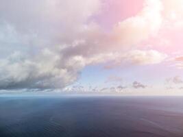 Aerial view. The drone flies over foggy and fluffy clouds. Blue sky sun and sea fog. Abstract aerial nature summer ocean sunset sea and sky background. Horizon. Vacation, travel and holiday concept photo