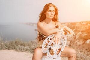 Happy boho woman portrait. Boho chic fashion style. Outdoor photo of free happy woman with long hair, sunny weather outdoors with sea mountains nature beautiful background.