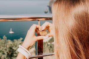 Hands, lock, heart, love, valentines day. Close-up of a woman's hands holding heart shaped padlock with a heart. The concept of Valentine's day, wedding, symbol of love and fidelity. photo