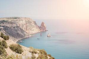 Aerial view from above on calm azure sea and volcanic rocky shores. Small waves on water surface in motion blur. Nature summer ocean sea beach background. Nobody. Holiday, vacation and travel concept photo