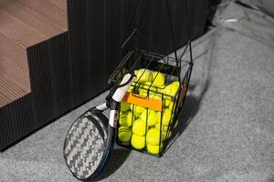 paddle tennis objects in court, racket and balls photo