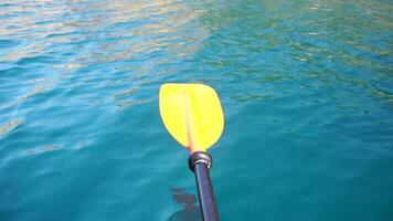 Kayak, paddle, sunset - Low angle view over clear azure sea water. Sun glare. Abstract nautical summer ocean nature. Holiday, vacation and travel concept. video