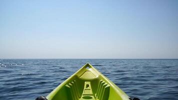 Sea water surface. Low angle view from kayak, camera flies over the clear green sea water. Nobody. Holiday recreation concept. Abstract nautical summer ocean nature. Slow motion. Close up. video