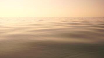 Sea water surface. Low angle view from kayak, camera flies over clear sea water. Nobody. Holiday recreation concept. Abstract nautical summer ocean nature. Slow motion. Close up. Vertical video