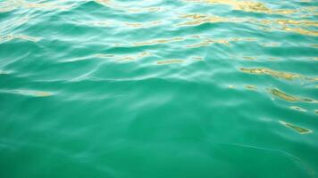 Sea water surface. Low angle view from kayak, camera flies over clear sea water. Nobody. Holiday recreation concept. Abstract nautical summer ocean nature. Slow motion. Close up. Vertical video