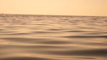 Sea water surface. Low angle view from kayak, camera flies over clear sea water. Nobody. Holiday recreation concept. Abstract nautical summer ocean nature. Slow motion. Close up. Vertical video