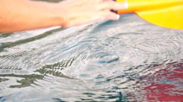 Woman hand sea. Close-up Happy Woman gently caresses water surface at sunset in a warm, golden evening by the sea or lake. Slow-motion Concept of happiness, boat life and holidays in exotic places video