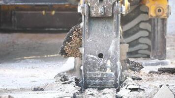 Excavator digs a trench to lay pipes. Close up of an excavator digging a deep trench. An excavator digs a trench in the countryside to lay a water pipe. Slow motion video