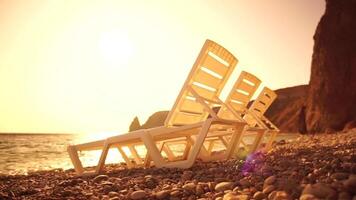 rijen van leeg wit plastic stoel en zonnen bedden Aan strand in de buurt zee Bij zonsondergang. ontspanning Oppervlakte voor chillen uit Aan zomer. strand stoelen en zon ligstoelen buitenshuis. zomer vakantie toevlucht concept. video