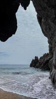 Cave Framed Tranquil Rocky Beach View photo