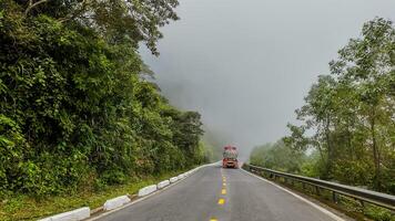 Misty Mountain Journey, Colorful Truck Amidst Green Landscape photo