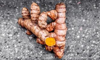 Fresh Turmeric Root on Textured Grey Background photo