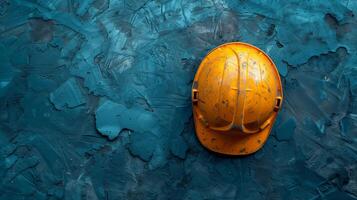 AI generated Construction concept, top view of a used yellow safety helmet on a textured dark blue industrial background with copy space photo