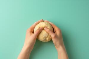 AI generated A pair of hands gently shaping a matzah ball from dough, isolated on a gradient background photo