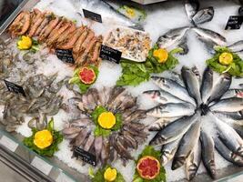 pescado y Mariscos hermosamente arreglado en hielo en el mostrador foto