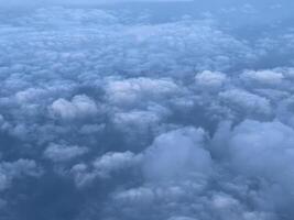 Porthole view of cumulus clouds on blue sky photo