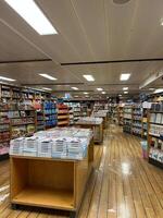 Herceg-Novi, Montenegro - 17 august 2023. Rows with colorful books on shelves in a bookstore photo