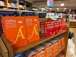 Herceg-Novi, Montenegro - 17 august 2023. Shelves with colorful Spanish dictionaries in a bookstore photo